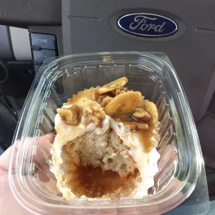 Banana bread cupcake with cream cheese frosting and a caramelized banana chip and walnut sauce.