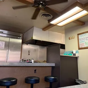 a kitchen with a ceiling fan