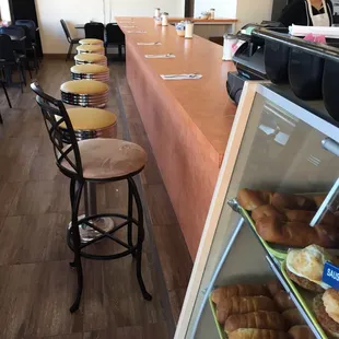 a view of a counter with a variety of pastries