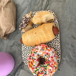 Cheese Kolache, glazed donut, sprinkle and a coconut donut.