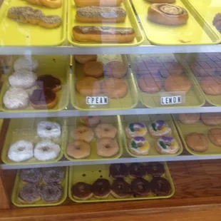a variety of donuts in a display case