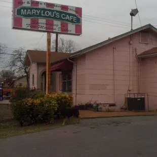 a pink building with a sign for mary lou&apos;s cafe