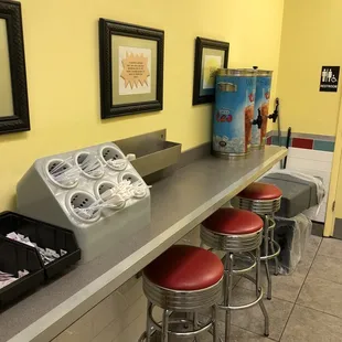 a counter with red stools