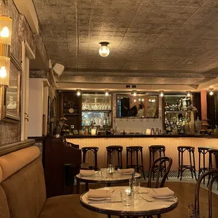 the interior of a restaurant with tables and chairs
