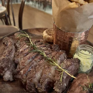 steak and fries on a wooden platter
