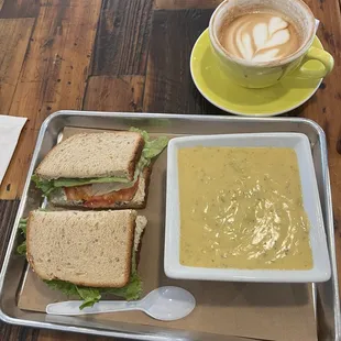 Chicken salad sandwich with bowl of broccoli cheddar soup