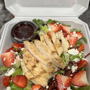 a salad in a styrofoam container