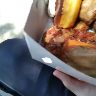 a person holding a box of doughnuts