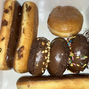 Some cake, donuts, and some eclairs and some jelly filled.
