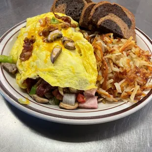 an omelet, hash browns, and bread