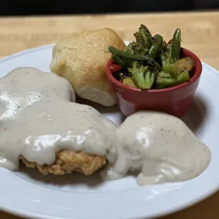 A hearty 8oz chicken Fried Chicken Breast with made from scratch mashed potatoes and cream gravy