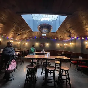 a woman standing in a dimly lit restaurant