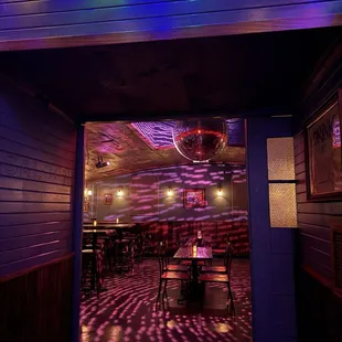 brightly lit tables and chairs in a restaurant