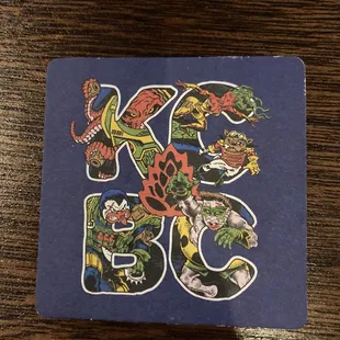 a blue coaster with a picture of a dragon and a dragon on it