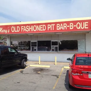 ows two cars parked in front