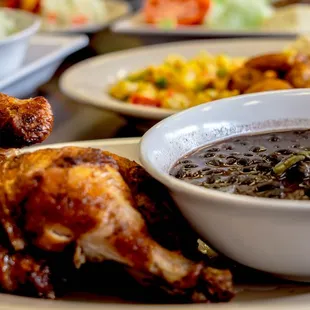 a bowl of soup and a plate of chicken