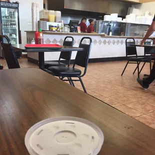 You can see the kitchen behind the counter from the dining area.
