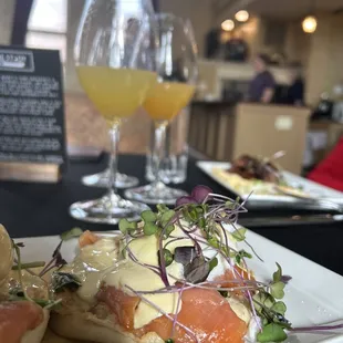 a plate of food and a glass of orange juice