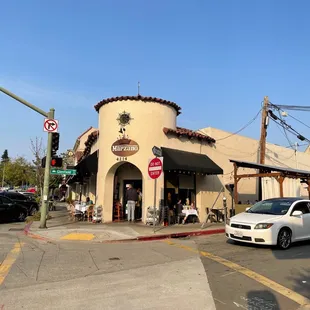 a white car parked in front of a restaurant