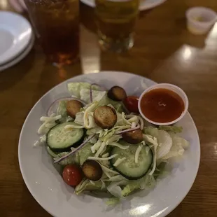 a salad with cucumbers and tomatoes