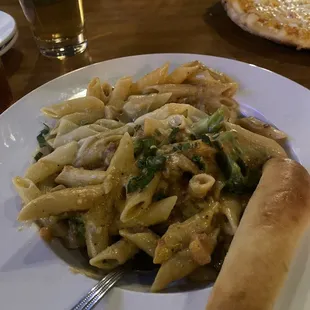 a plate of pasta and a hot dog
