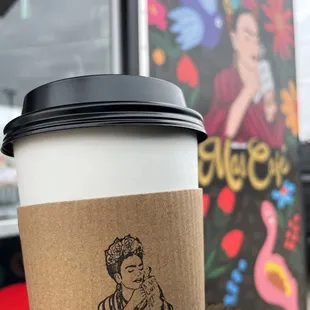 a hand holding a coffee cup