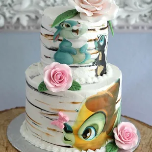 a three tiered cake decorated with disney characters