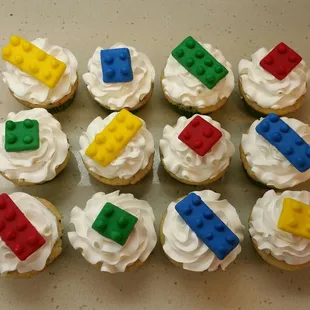 a group of cupcakes with lego blocks on them