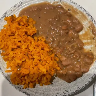 a plate of food with rice and beans