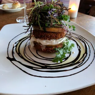 Fried green tomato burrata Napoleon top with an arugula  mizuna salad
