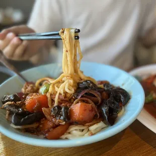 a plate of noodles and meat