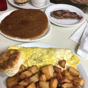 Southwestern omelette with sides home fries and biscuit. Steak and eggs platter with English muffin and grits.