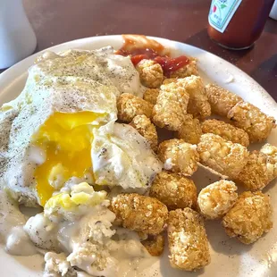 Sausage gravy &amp; biscuits (with an egg added) with tots. All cooked perfectly. Yum $8.99+1.99.