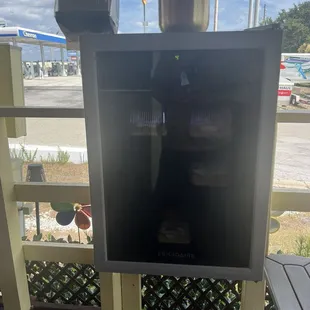 Small fridge in seating area with treats