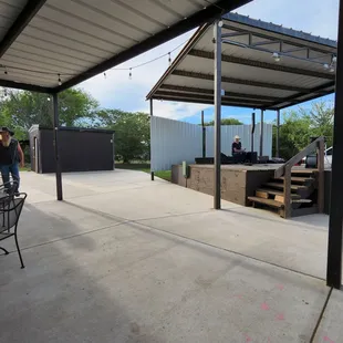 a patio with a bbq and patio furniture
