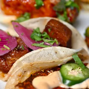 a variety of tacos on a plate