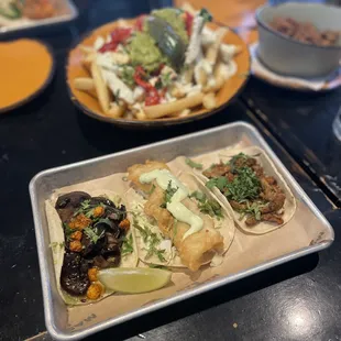 mushroom taco, battered fish taco, pork al pastor taco