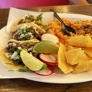 Delicious Carne Asada and Carnitas Tacos!  Platter comes with tortilla chips, beans and rice.