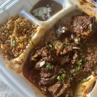 Birria plate looks messy due to sauce and beans spilling but,  was very delicious!