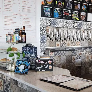 a bar with a menu on the wall