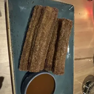 Crispy churros with caramel sauce.