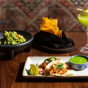 a plate of mexican food and a drink