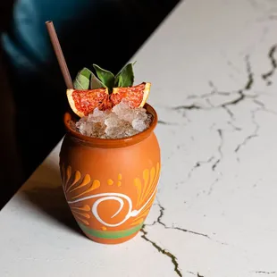 a drink in a vase on a table