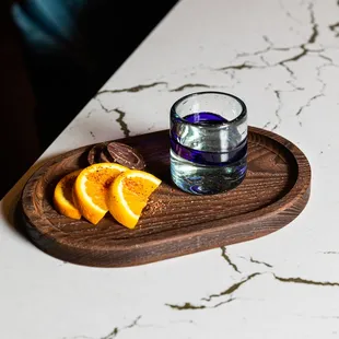 a glass of water and sliced oranges