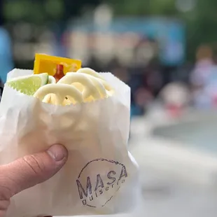a person holding a bag of ice cream