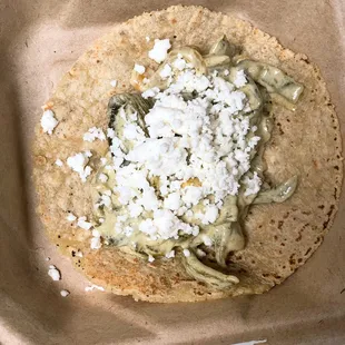 a tortilla topped with feta cheese