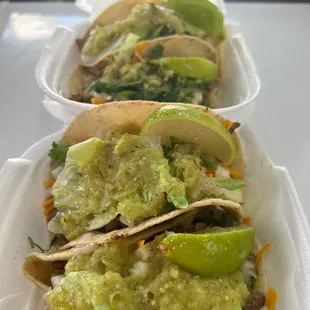 three tacos in a styrofoam container