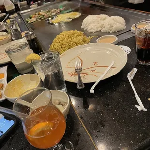 Chef cooking veggies, rice, eggs, and noodles Fried calamari, bahama mama, miso soup