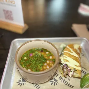 Birria taco and consomé