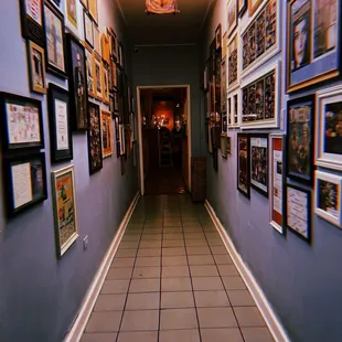 a long hallway with pictures on the wall